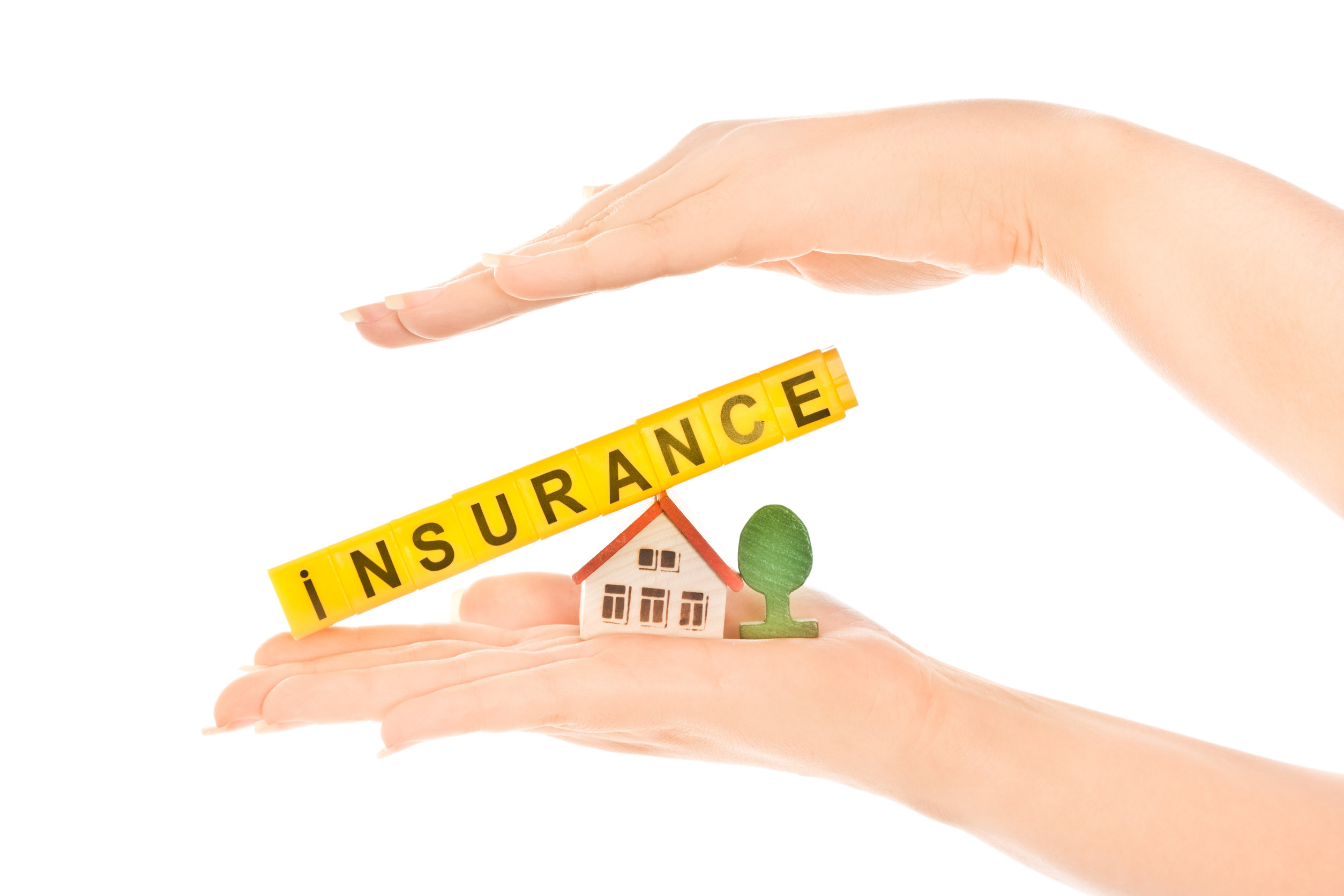 Woman hand holding house and word insurance